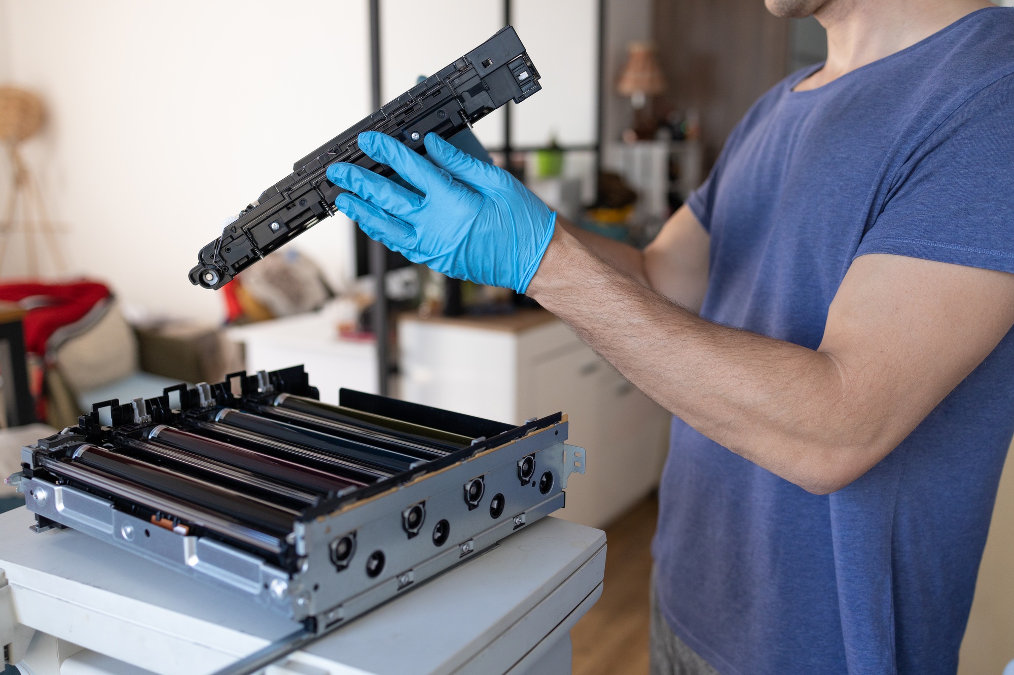 Close-up of a man repairing a photocopier in his office